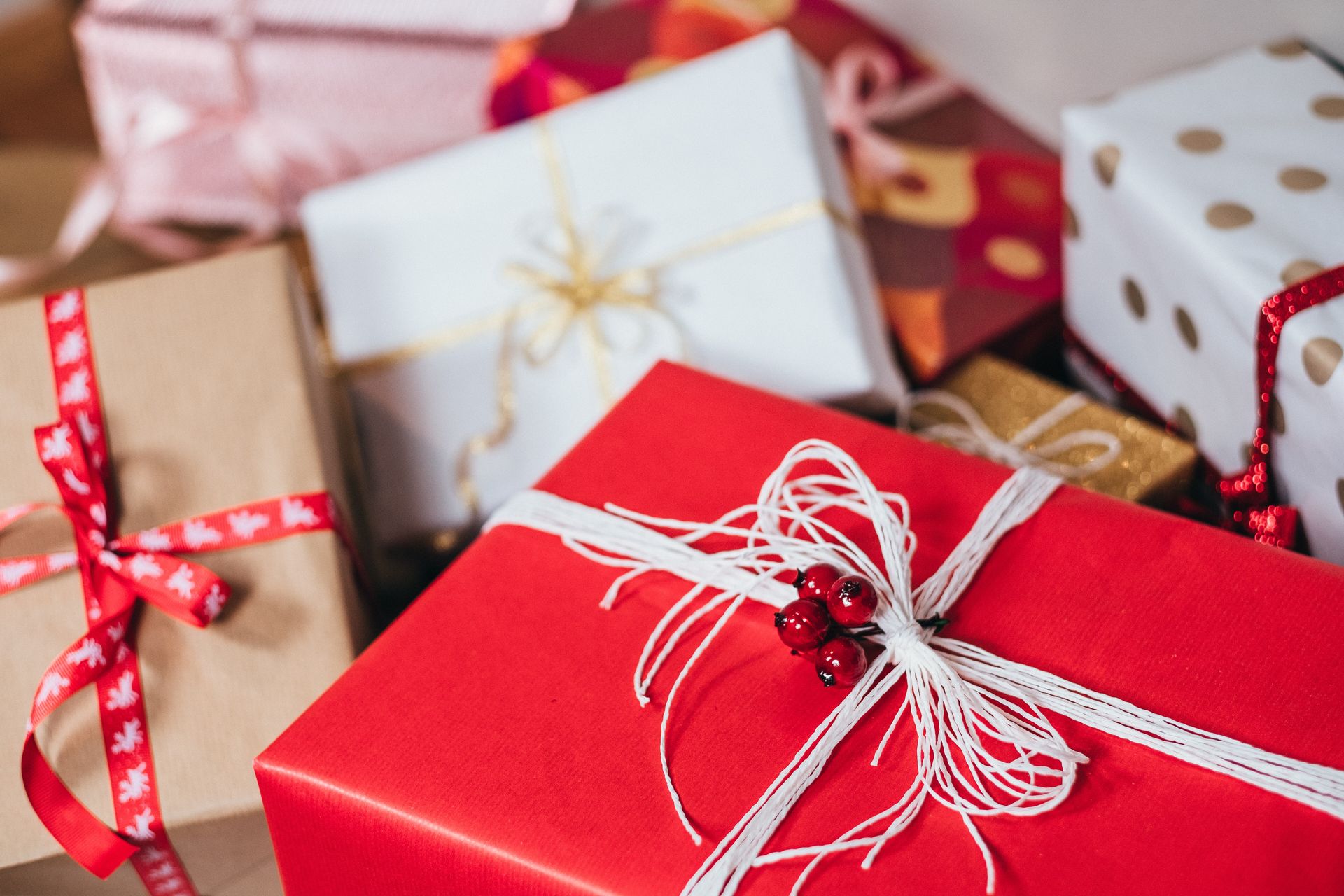 Picture of different presents wrapped in red, white and brown paper